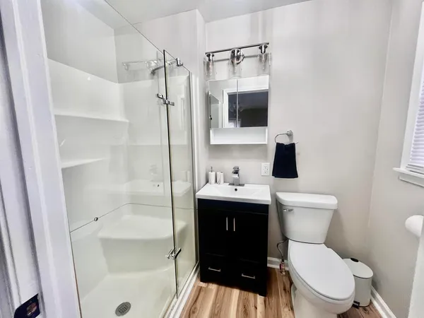 a bathroom with a toilet a sink and shower