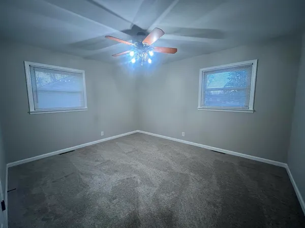 a view of an empty room with a fan
