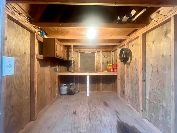 a view of a room with wooden floor and a window