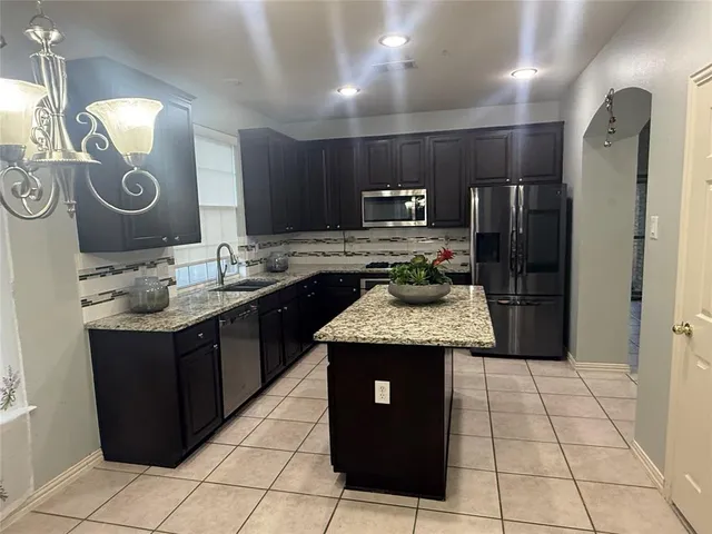 a kitchen with a stove and a refrigerator