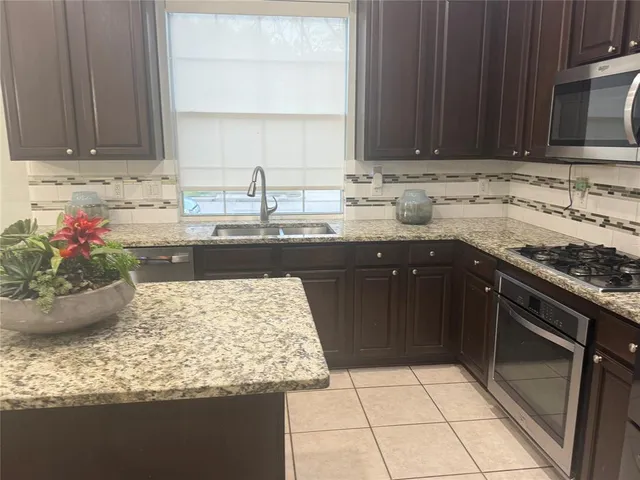 a kitchen with a sink stove and microwave