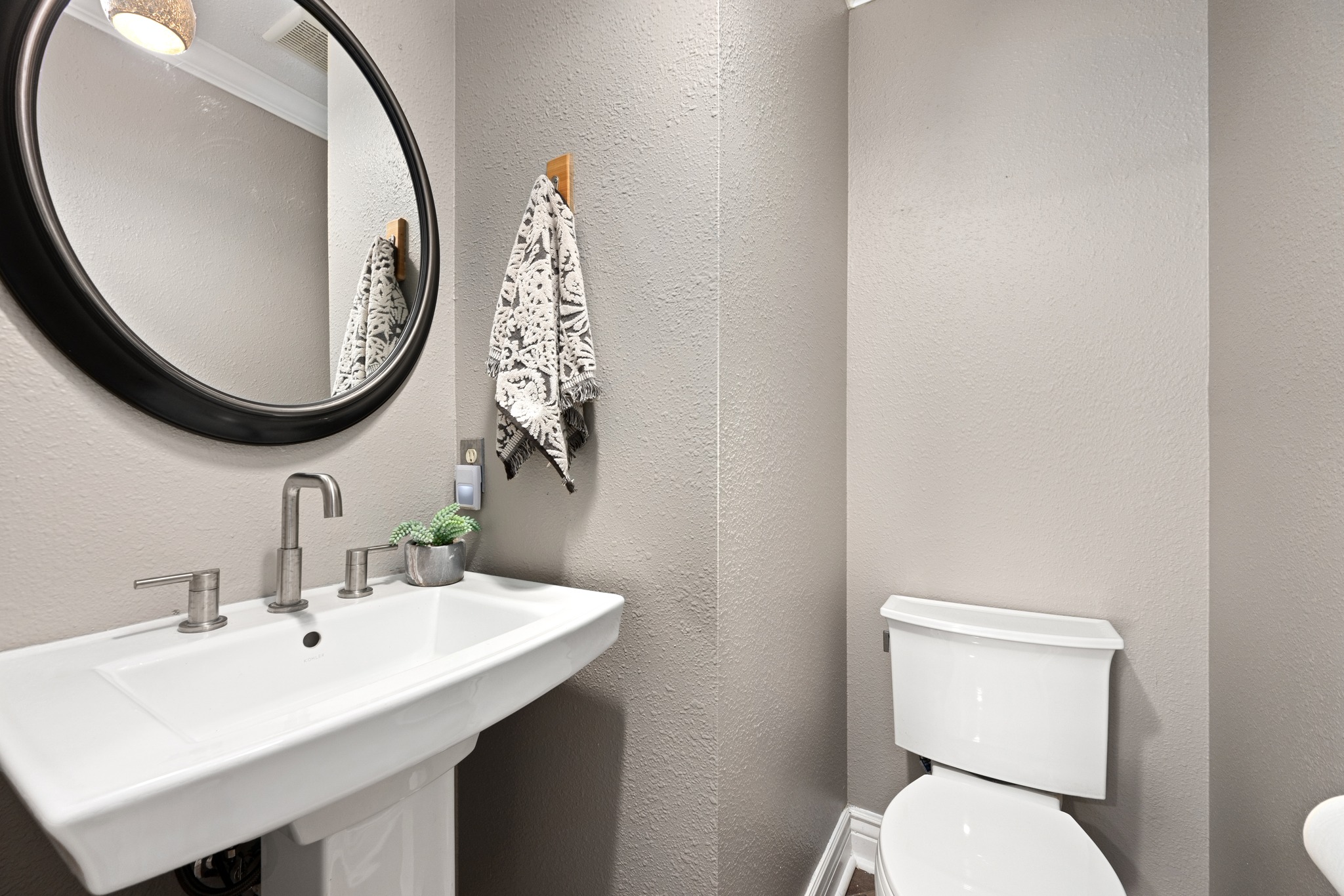 3908 Valley View Round Rock, TX 78681 - Photo 22 of 39 A stylish main-level powder room keeps things convenient for guests.