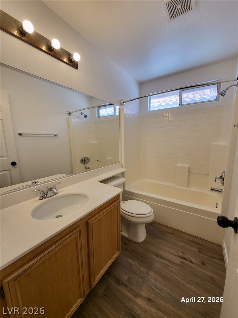 4548 Flaming Ridge Trail Las Vegas, NV 89147 - Photo 14 of 21 Clean lines and rich wood tones define this comfortable guest bathroom featuring a full tub.
