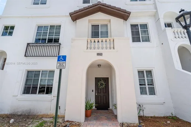 a front view of a house with iron fence