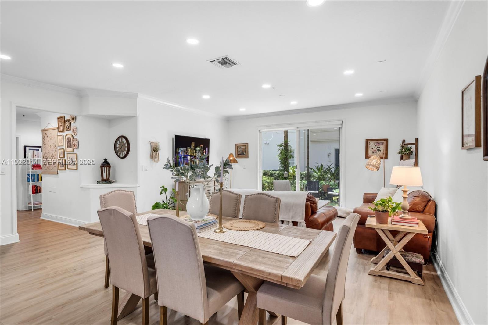 12430 Southwest 50th Street, Unit 109 Miramar, FL 33027 - Photo 14 of 28 a dining room with furniture and wooden floor