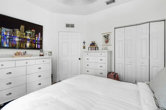 a bedroom with a bed and a dresser