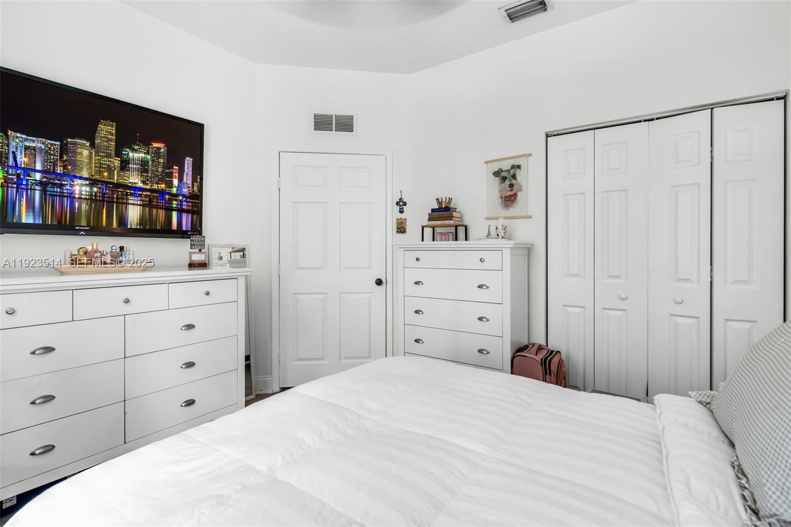 12430 Southwest 50th Street, Unit 109 Miramar, FL 33027 - Photo 16 of 28 a bedroom with a bed and a dresser