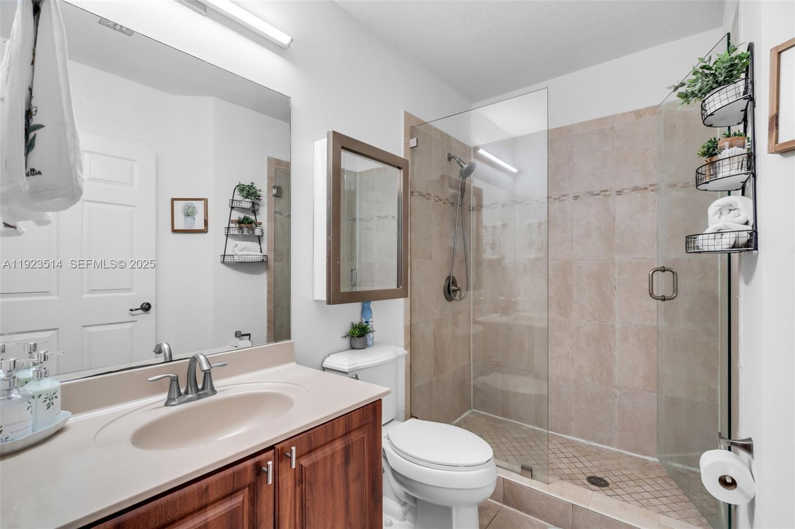 12430 Southwest 50th Street, Unit 109 Miramar, FL 33027 - Photo 17 of 28 a bathroom with a sink toilet and shower