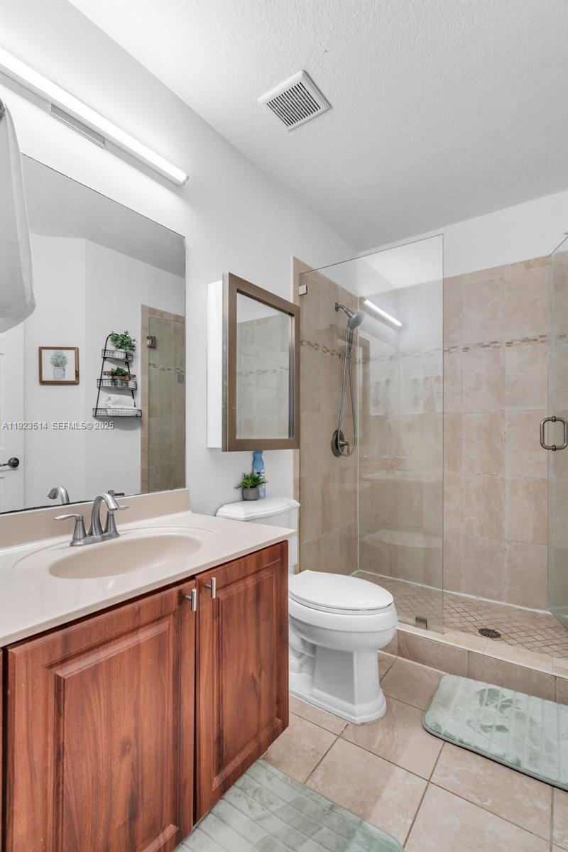 12430 Southwest 50th Street, Unit 109 Miramar, FL 33027 - Photo 18 of 28 a bathroom with a sink toilet and shower