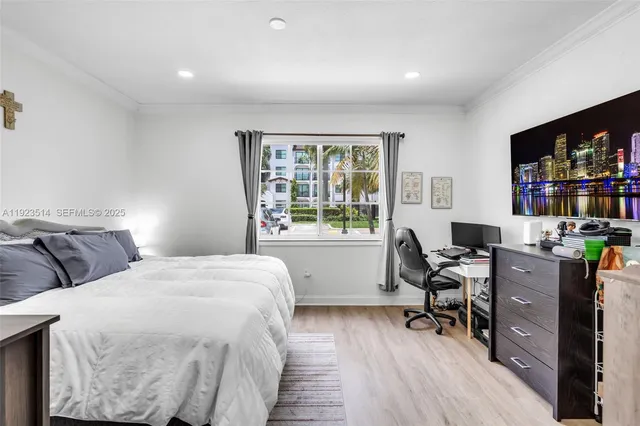 a bedroom with two beds and a desk