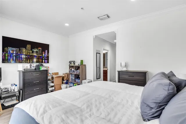 a bedroom with a bed and dresser