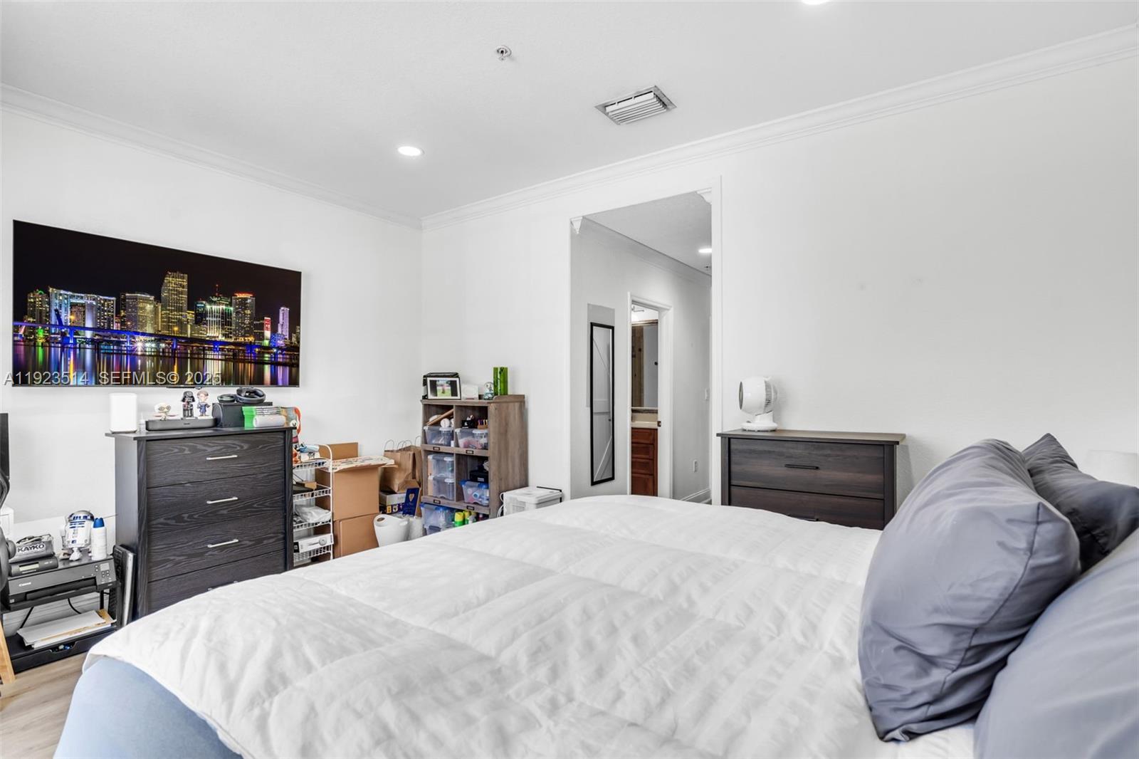 12430 Southwest 50th Street, Unit 109 Miramar, FL 33027 - Photo 21 of 28 a bedroom with a bed and dresser