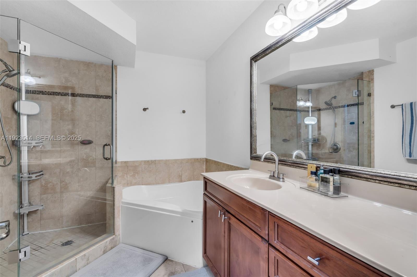 12430 Southwest 50th Street, Unit 109 Miramar, FL 33027 - Photo 22 of 28 a bathroom with a sink a toilet and shower