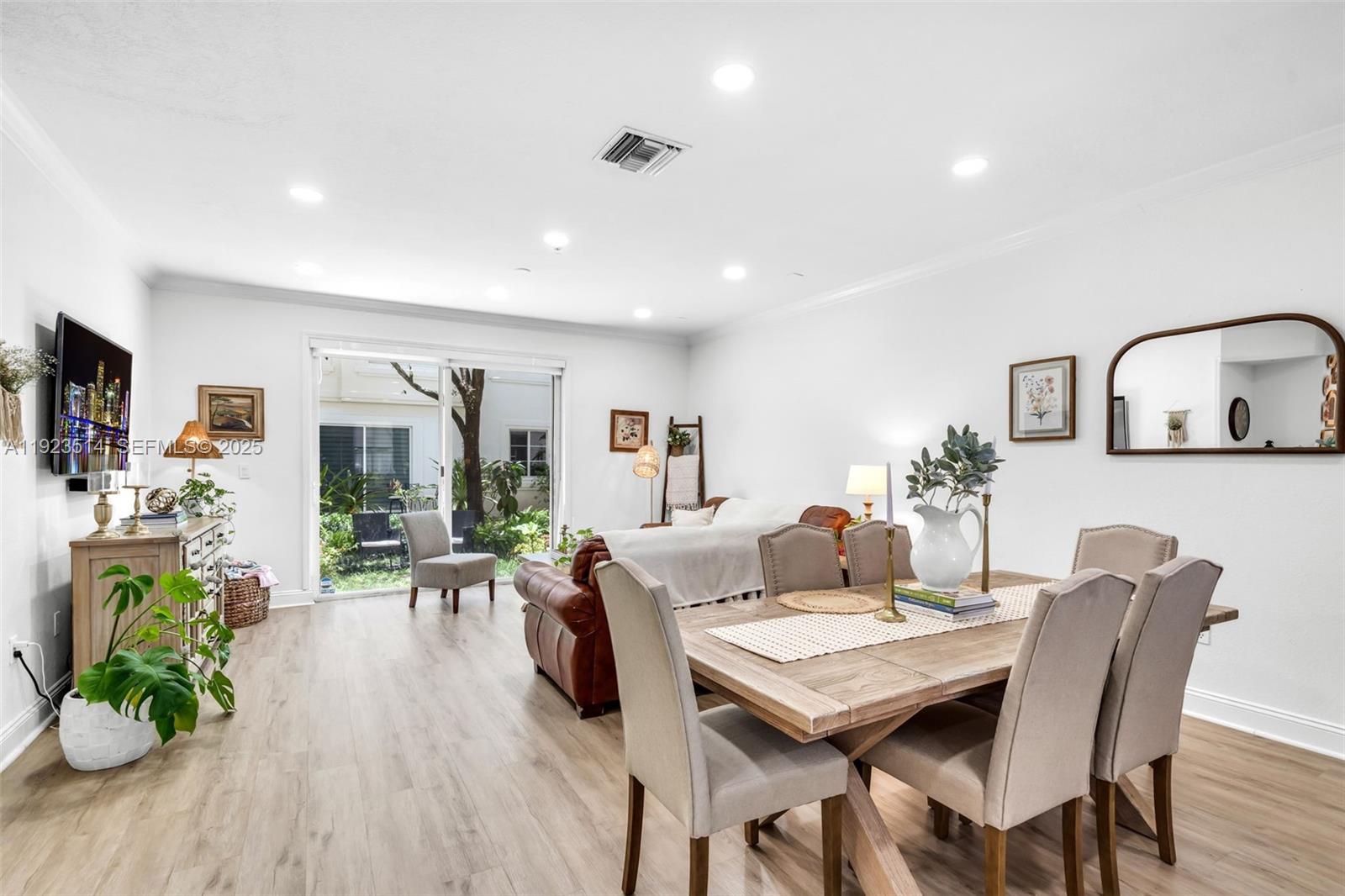 12430 Southwest 50th Street, Unit 109 Miramar, FL 33027 - Photo 5 of 28 a view of a dining room with furniture window and wooden floor