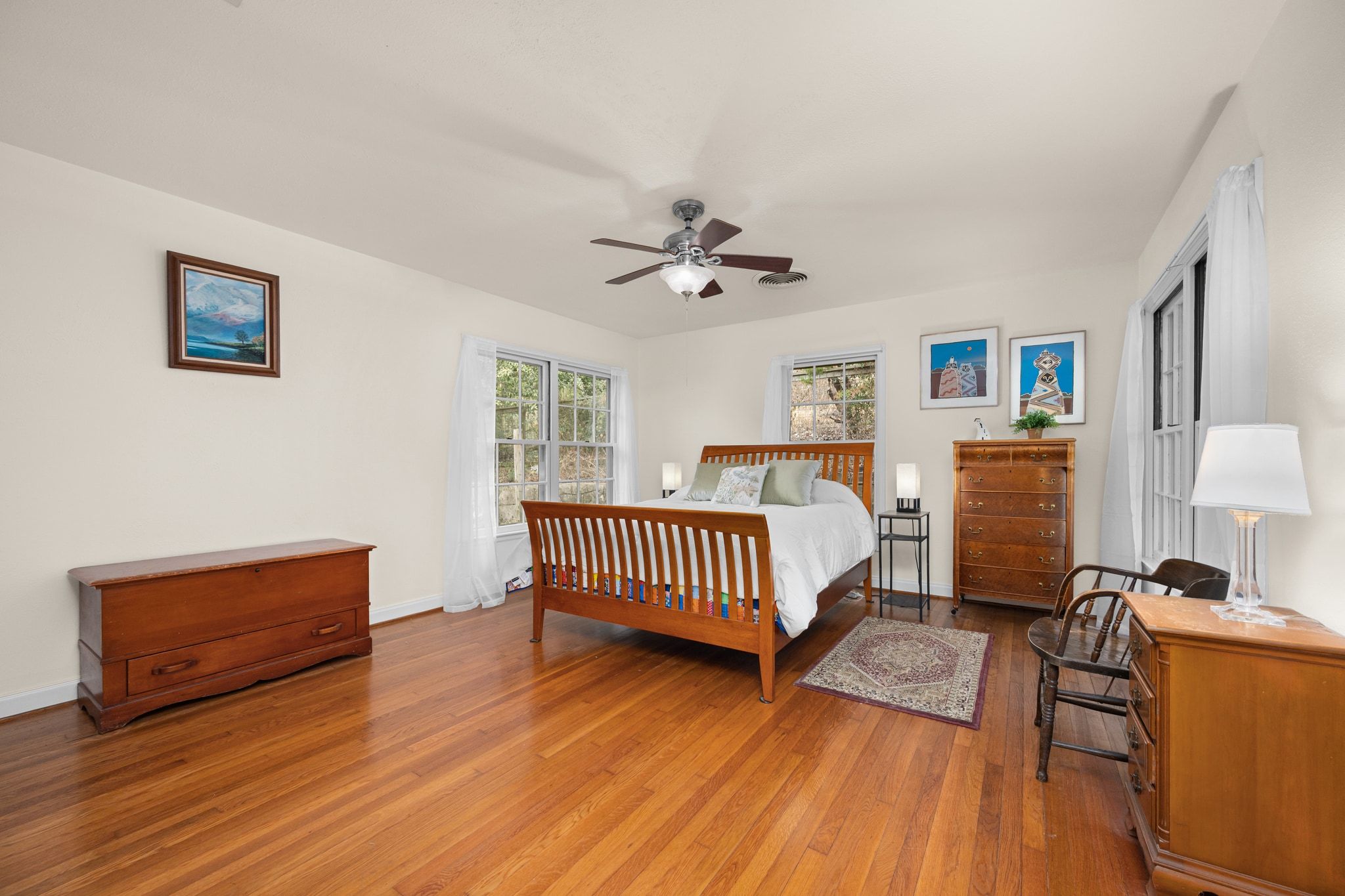 4804 Balcones Drive Austin, TX 78731 - Photo 14 of 27 a bedroom with furniture and a wooden floor