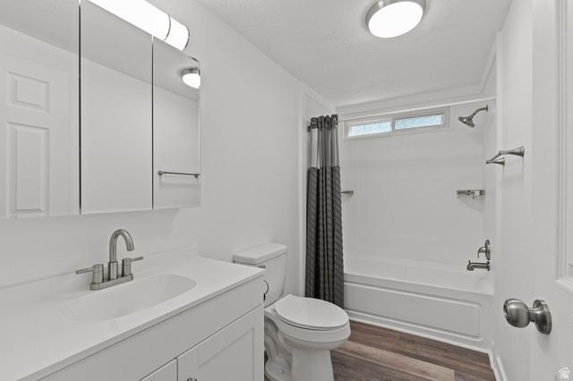 350 West 800 South, Unit 2 Logan, UT 84321 - Photo 8 of 22 Full bath with vanity, dark wood-style floors, shower / bath combo, and a textured ceiling