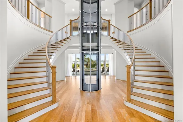a view of a dining room with furniture a chandelier and wooden floor