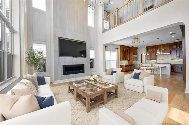 a living room with furniture a large window and a fireplace