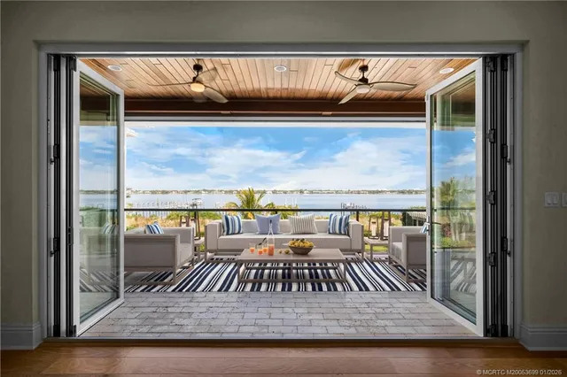 a spacious bedroom with a large bed and a chandelier