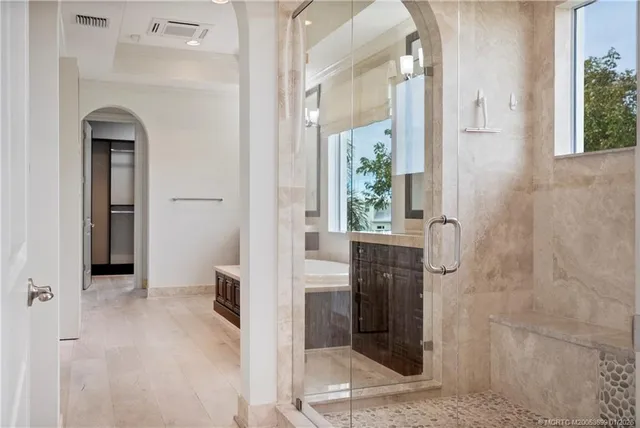 a bathroom with a granite countertop sink a mirror and a shower