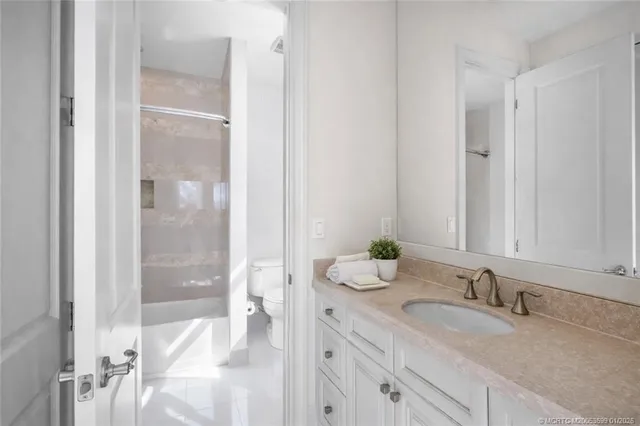 a bedroom with a bed and painting on the wall