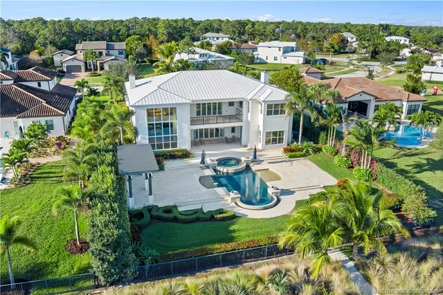 a aerial view of a houses with a lake