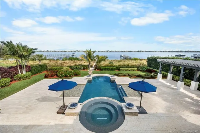 a view of a swimming pool next to a yard