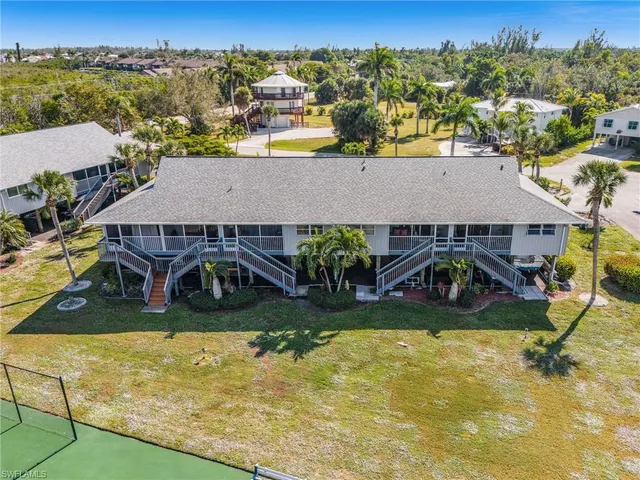 an aerial view of a house with swimming pool and mountains