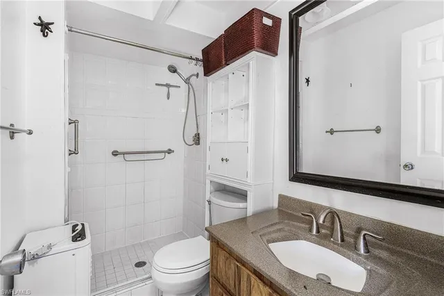a bathroom with a sink toilet tub and shower