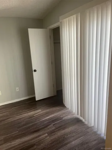 a view of a livingroom with wooden floor and a window
