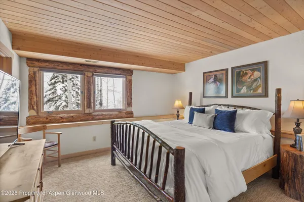 a bedroom with a large bed and a large window