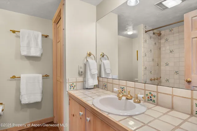 a bathroom with a sink double vanity and a mirror