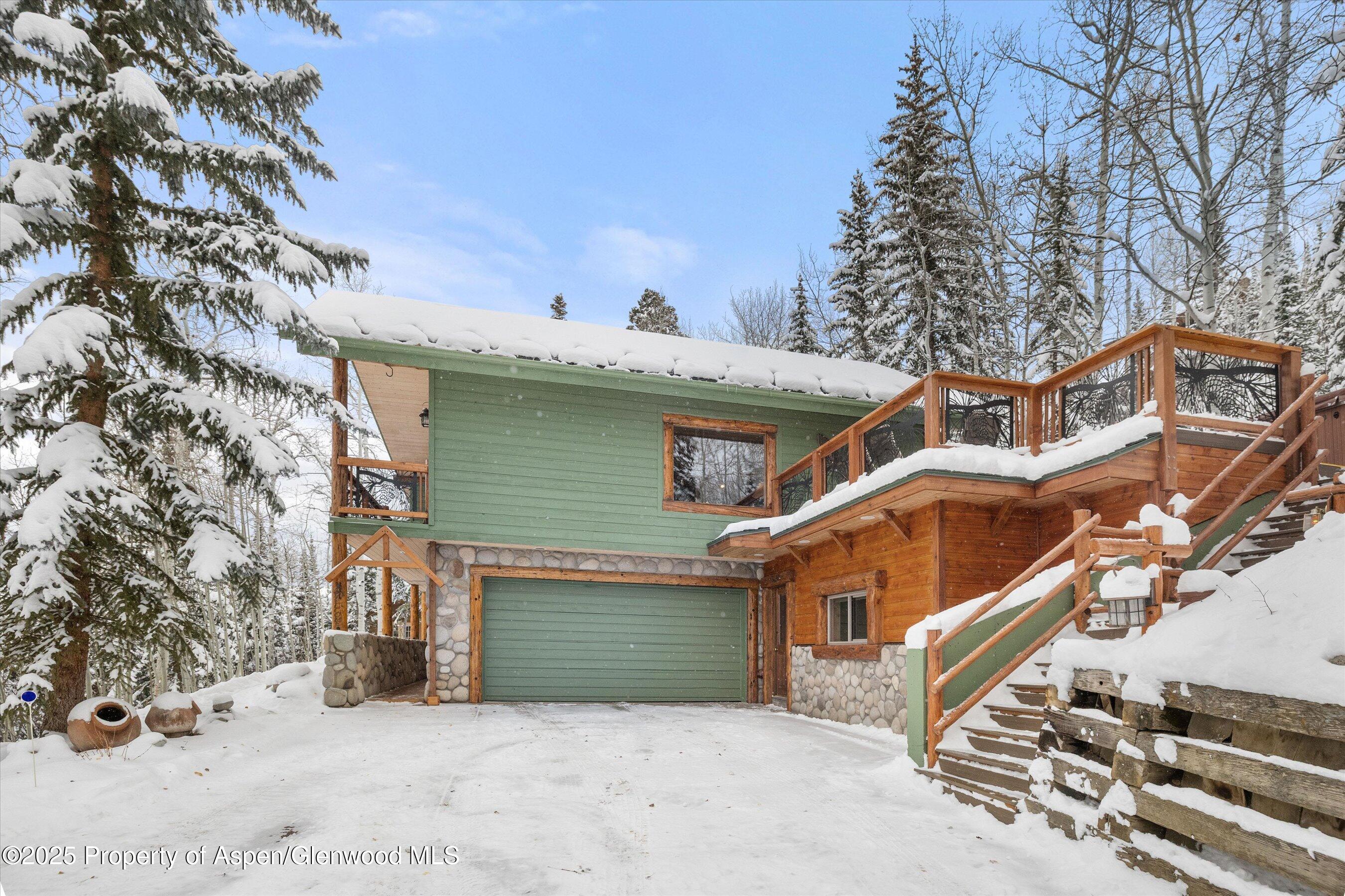 818 Faraway Road Snowmass Village, CO 81615 - Photo 22 of 24 a view of a house with a yard and wooden fence