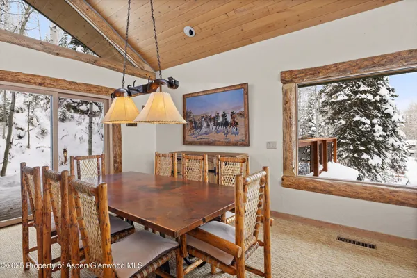 a dining room with furniture and window