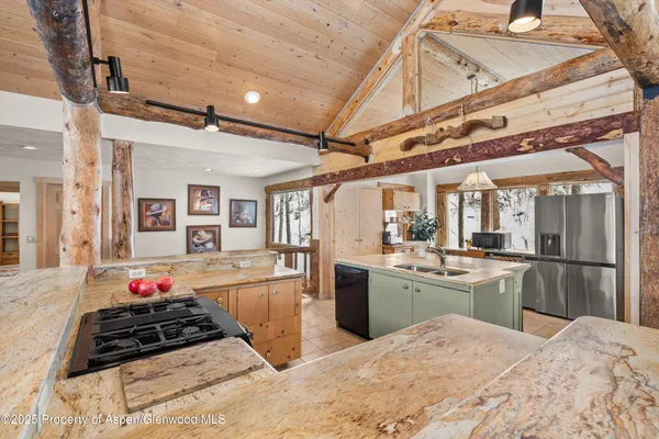 a kitchen with stainless steel appliances kitchen island granite countertop a stove and cabinets