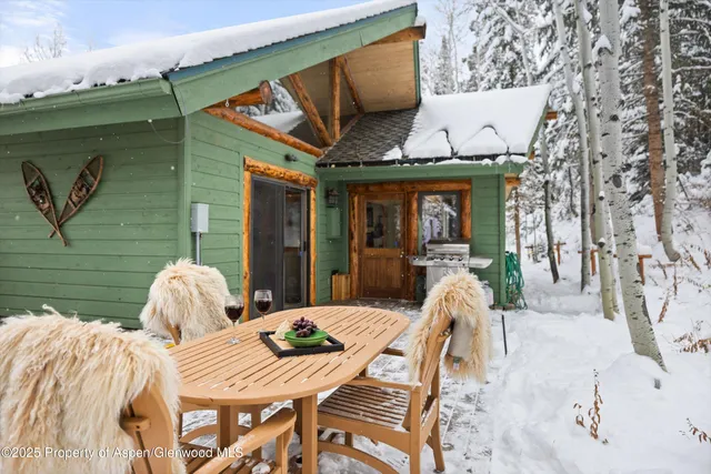 a view of a patio with table and chairs with wooden floor and fence