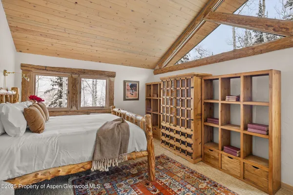 a bedroom with furniture and a large window