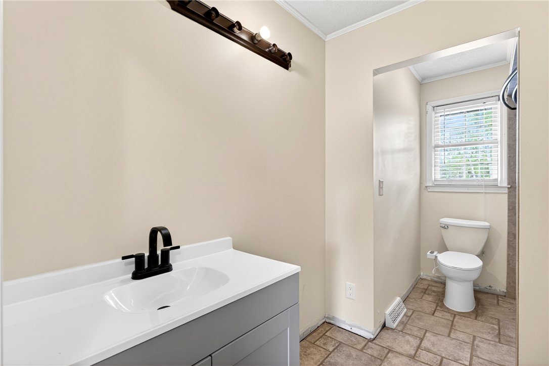 160 Burdette Circle Pendleton, SC 29670 - Photo 14 of 38 This bathroom features a contemporary vanity and practical toilet area with natural light.