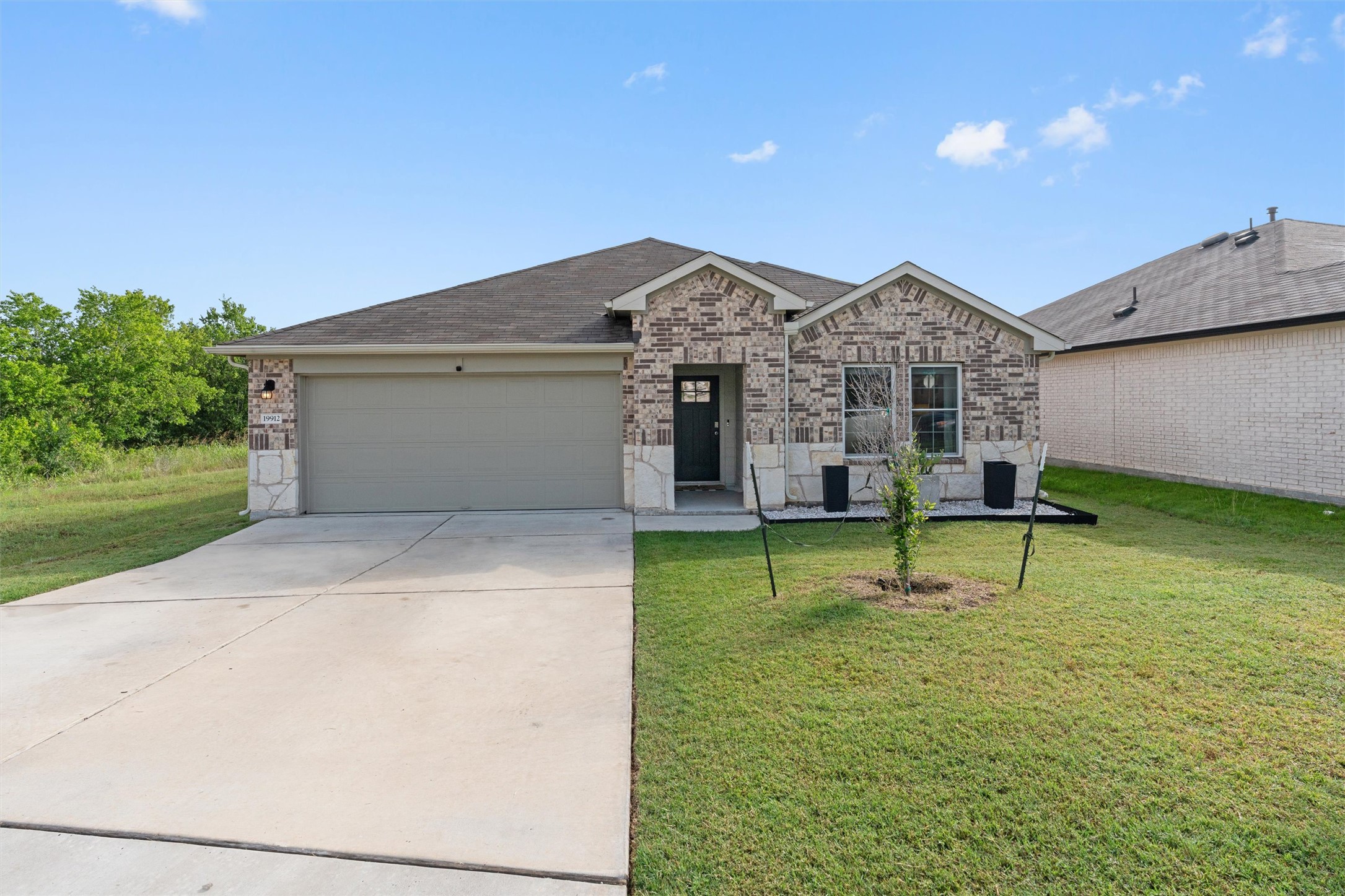 19912 Abigail Fillmore Road Manor, TX 78653 - Photo 1 of 31 A charming brick and stone facade welcomes you to this delightful single-story dwelling.