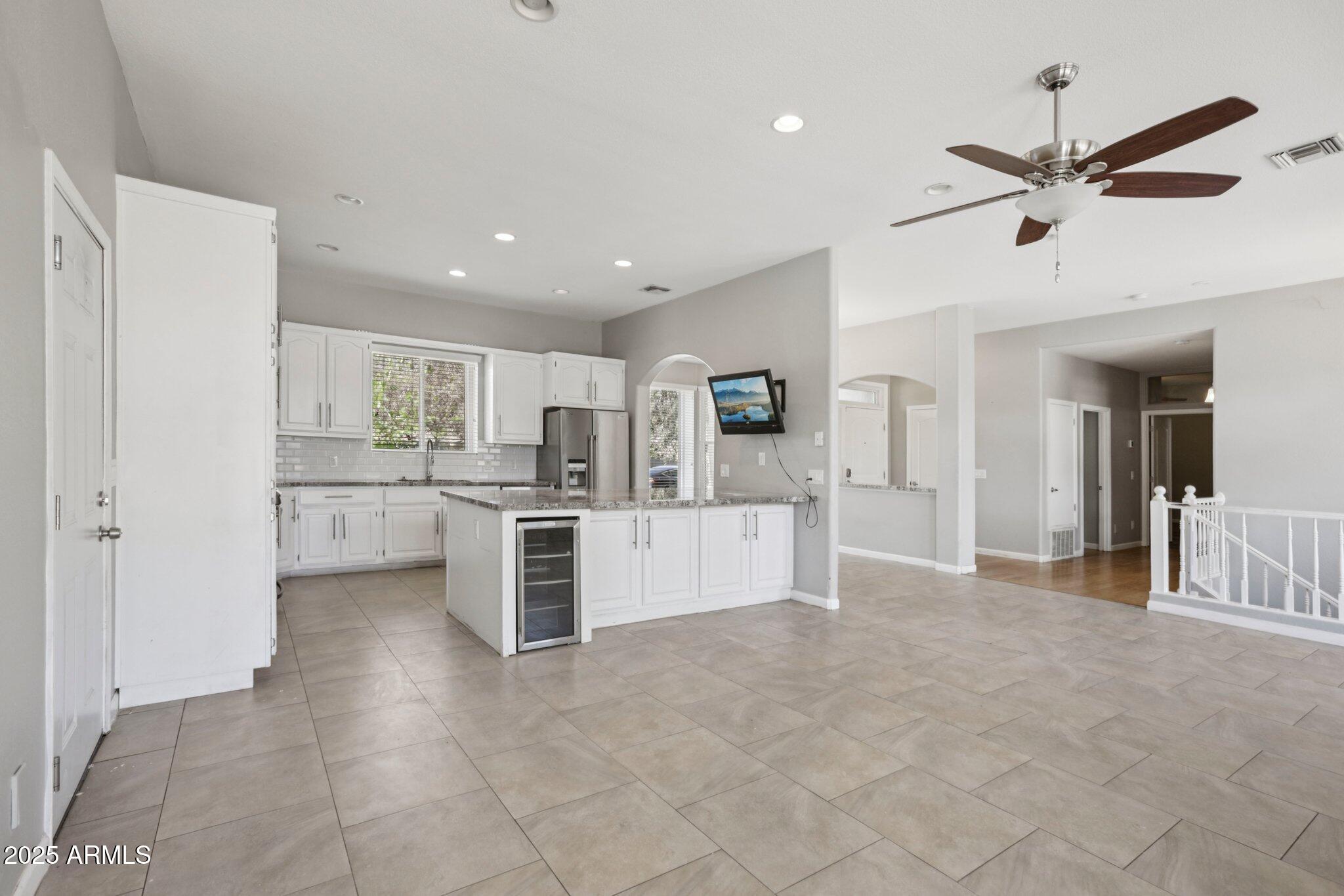 702 West Why Worry Lane Phoenix, AZ 85021 - Photo 10 of 46 a view of a kitchen with refrigerator and microwave