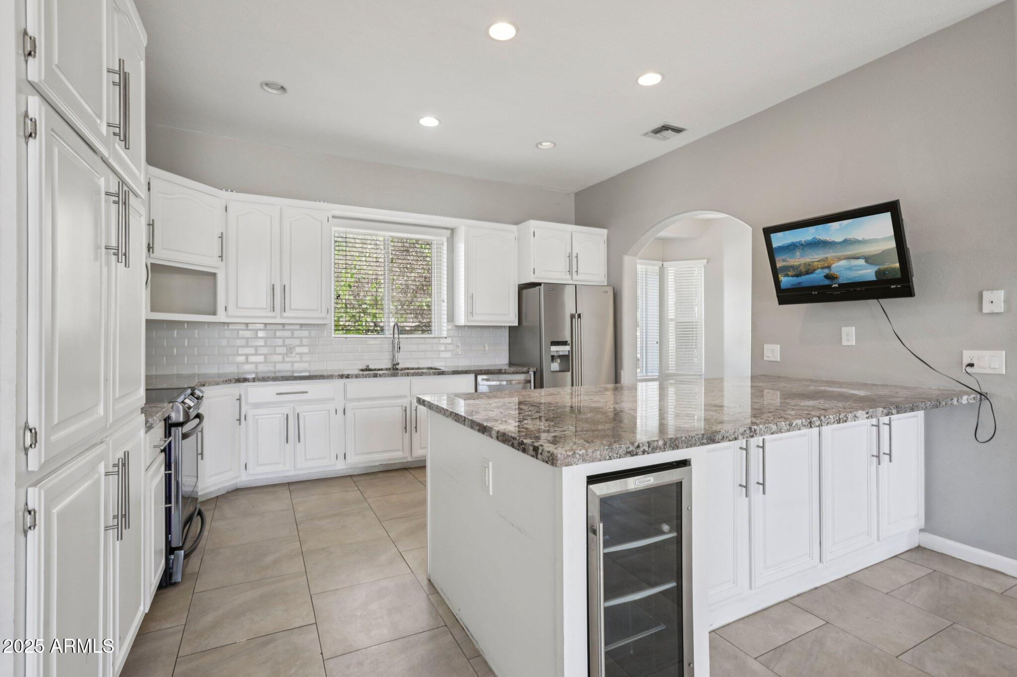 702 West Why Worry Lane Phoenix, AZ 85021 - Photo 11 of 46 a kitchen with stainless steel appliances granite countertop a sink and cabinets