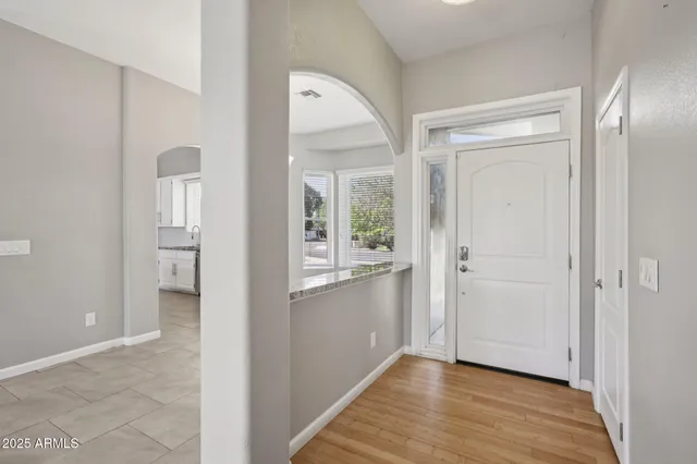 a kitchen with stainless steel appliances granite countertop white cabinets and a stove top oven
