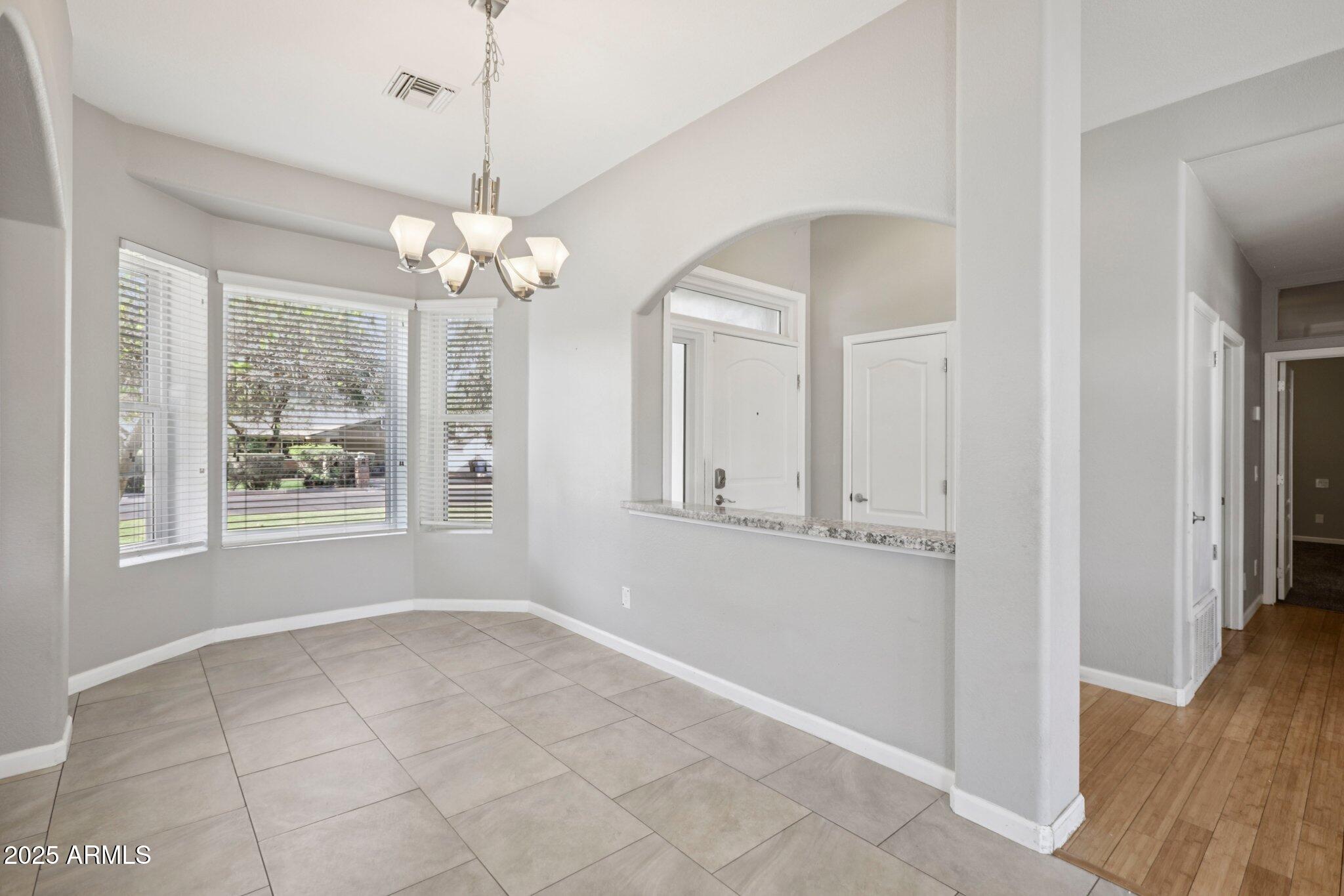 702 West Why Worry Lane Phoenix, AZ 85021 - Photo 14 of 46 a view of a livingroom with a chandelier fan and windows