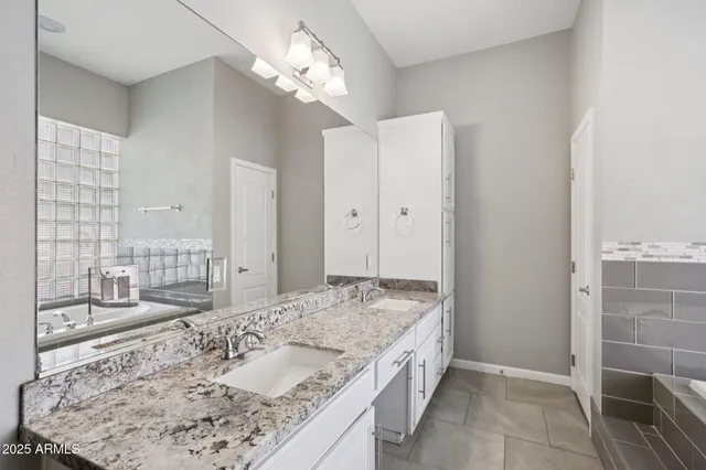 a bathroom with a granite countertop sink a toilet and shower