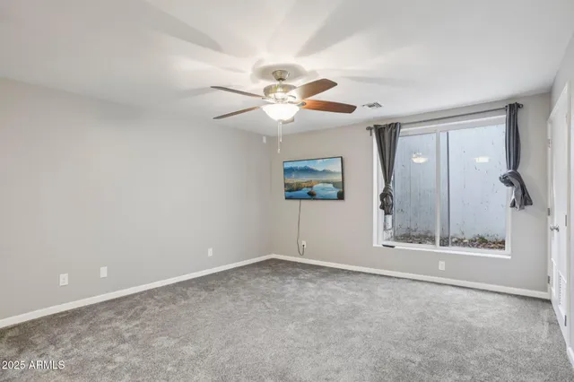 a bathroom with a granite countertop sink a large mirror and a shower