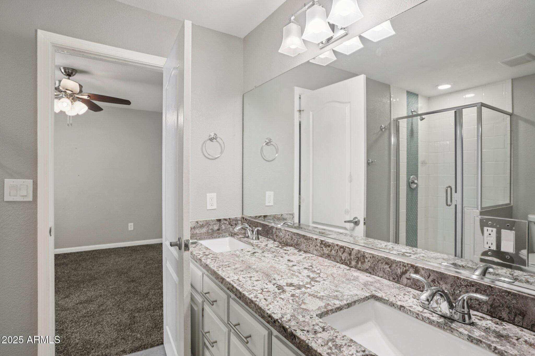 702 West Why Worry Lane Phoenix, AZ 85021 - Photo 27 of 46 a bathroom with a granite countertop sink and a mirror