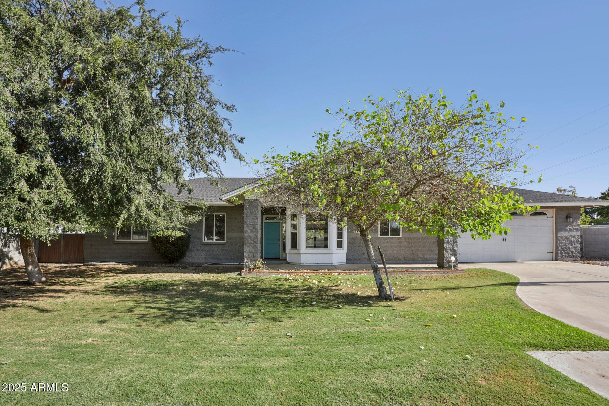 702 West Why Worry Lane Phoenix, AZ 85021 - Photo 2 of 46 a front view of a house with a yard