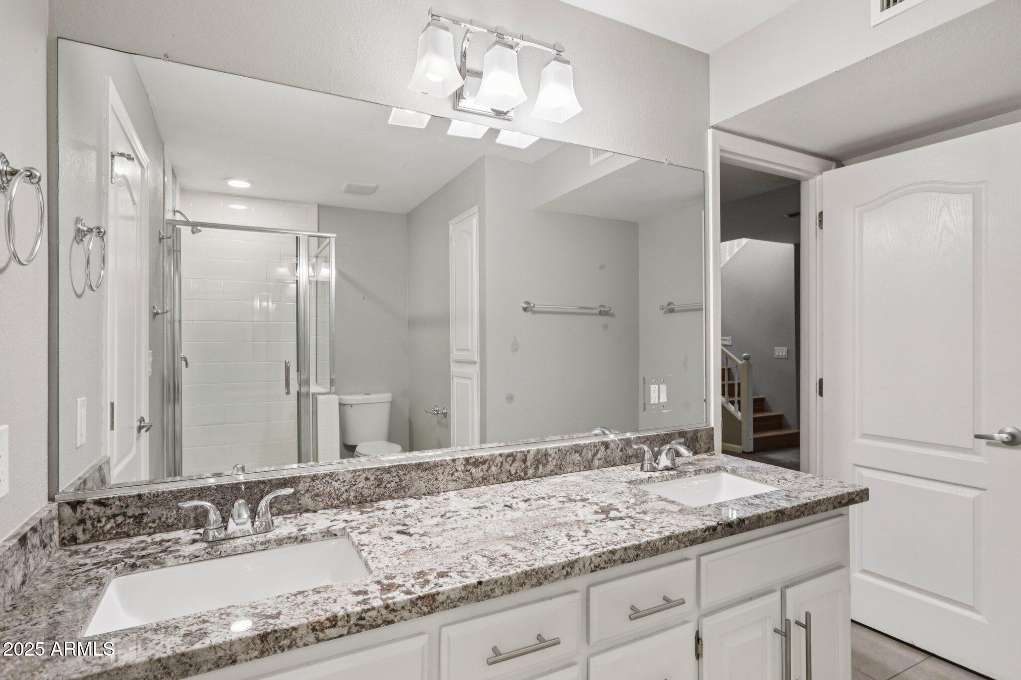 702 West Why Worry Lane Phoenix, AZ 85021 - Photo 29 of 46 a bathroom with a granite countertop double vanity sink and a mirror