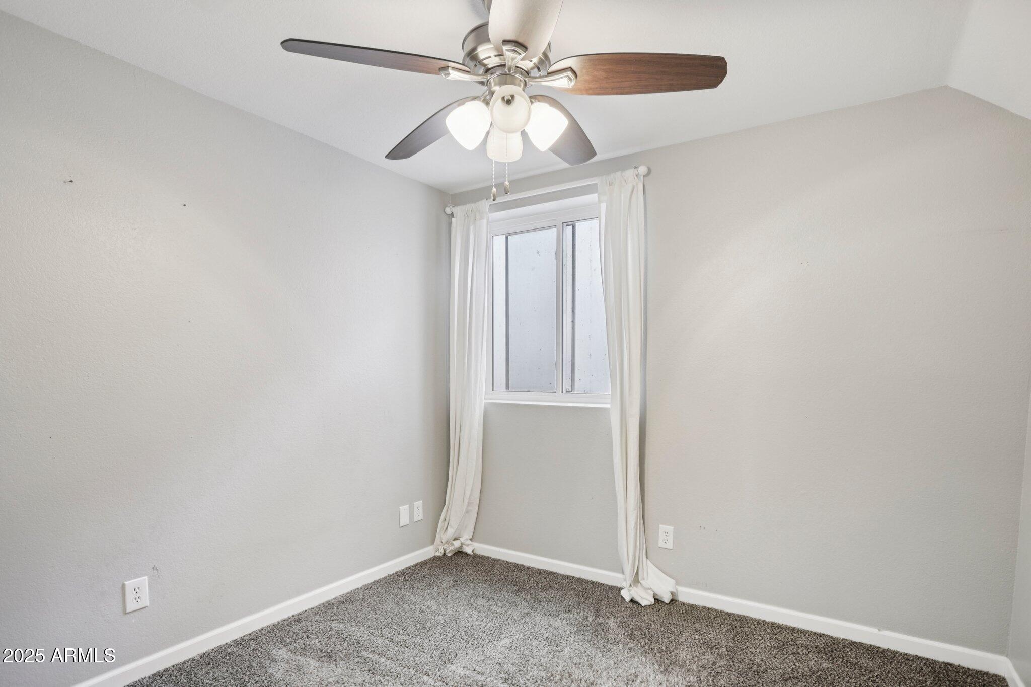 702 West Why Worry Lane Phoenix, AZ 85021 - Photo 30 of 46 an empty room with windows and fan