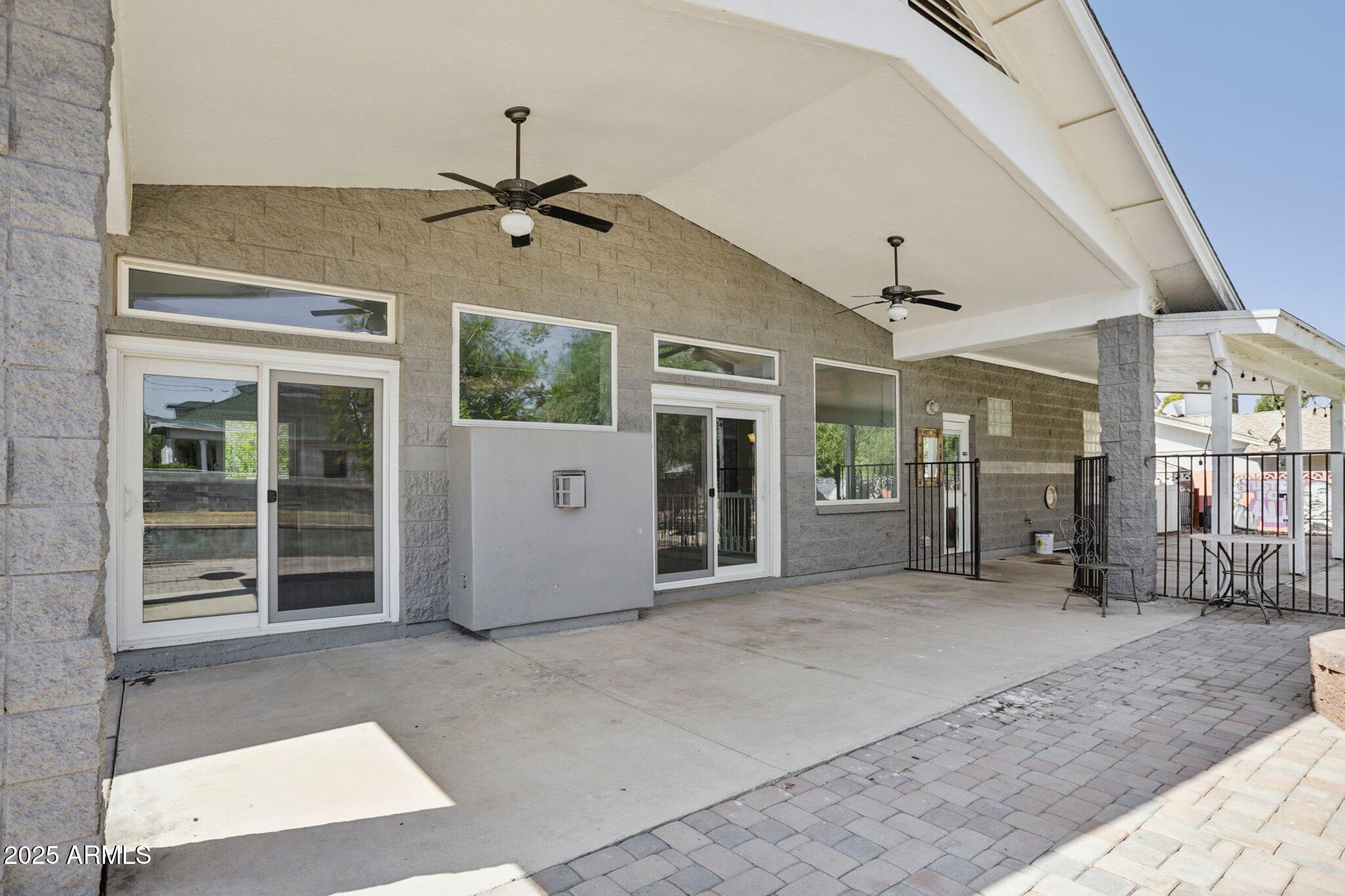 702 West Why Worry Lane Phoenix, AZ 85021 - Photo 35 of 46 a view of a hall with wooden floor and a ceiling fan